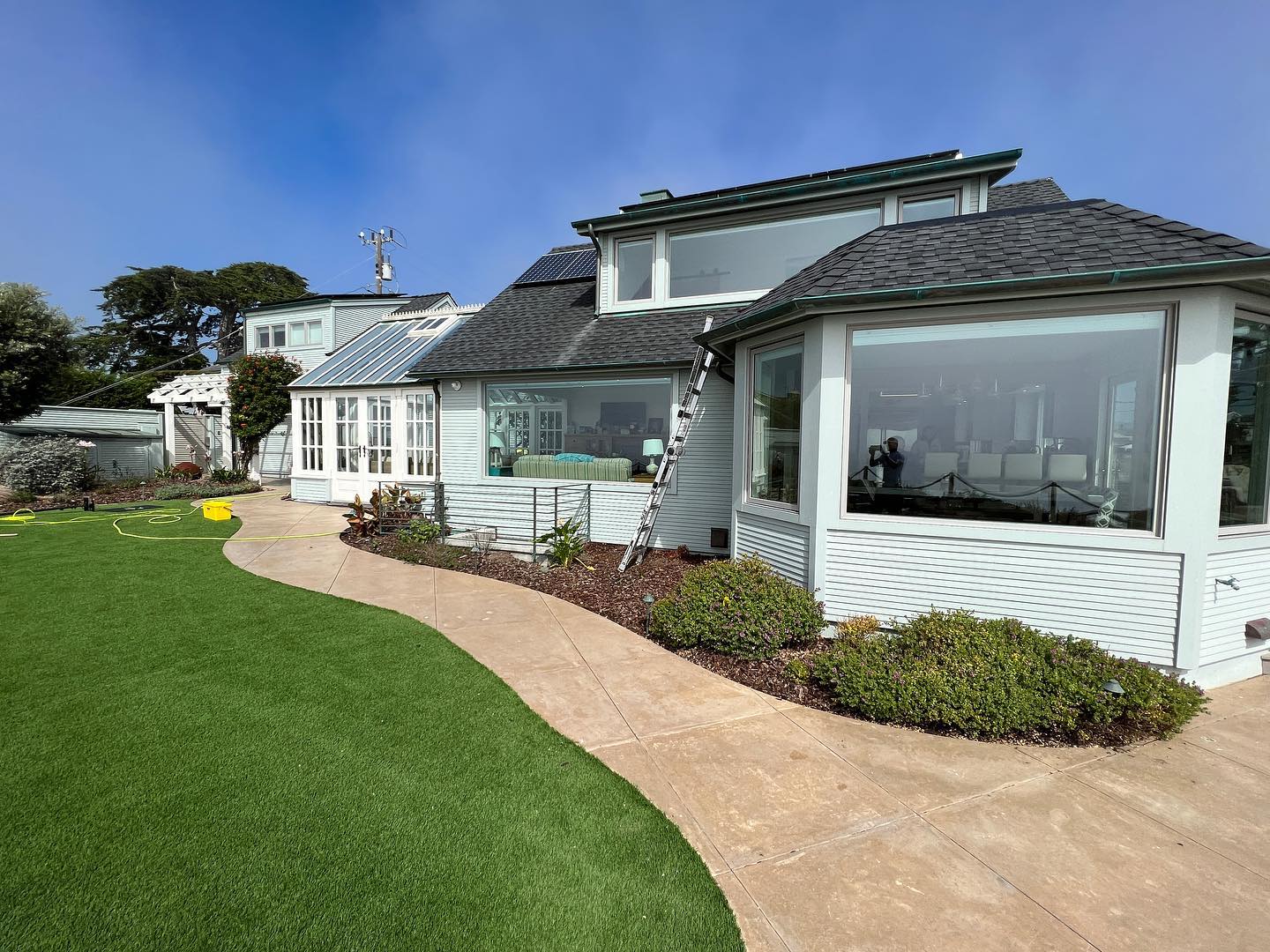 Modern house with large windows and lawn.