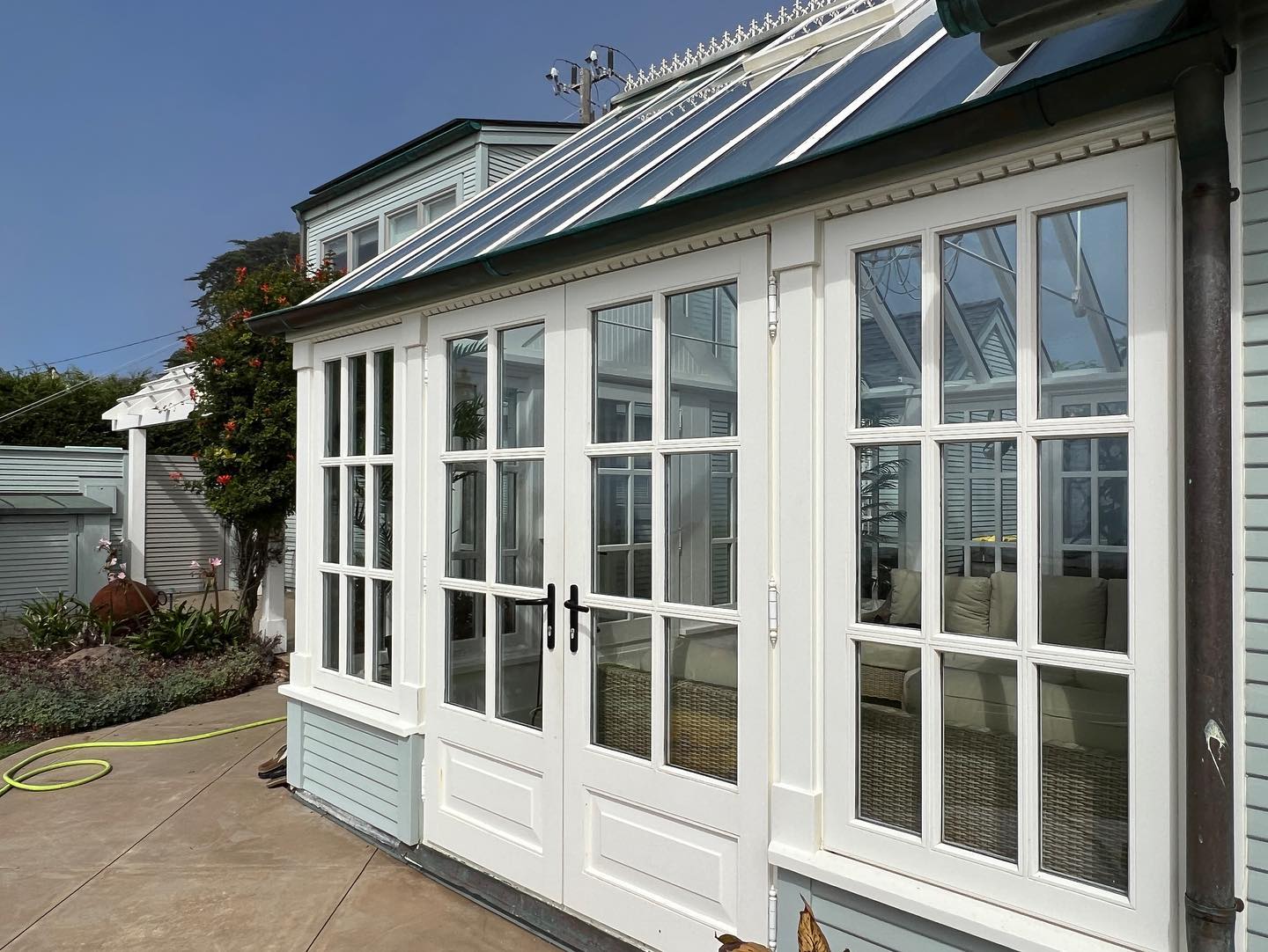White-framed glass doors of a sunroom.