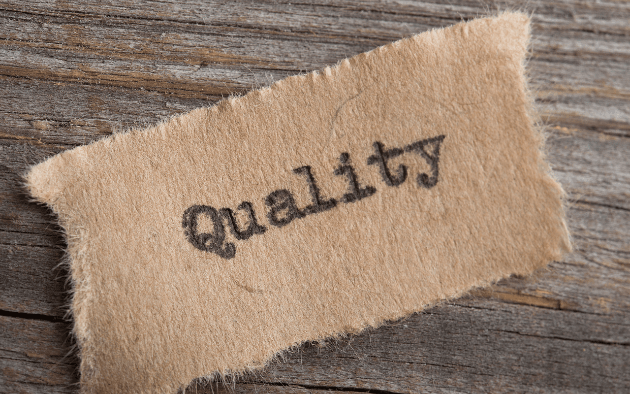 Text "Quality" on torn brown paper.