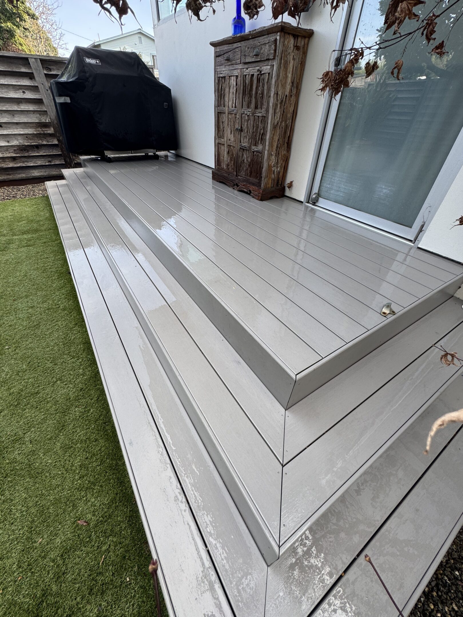 Wet modern patio with wooden cabinet.