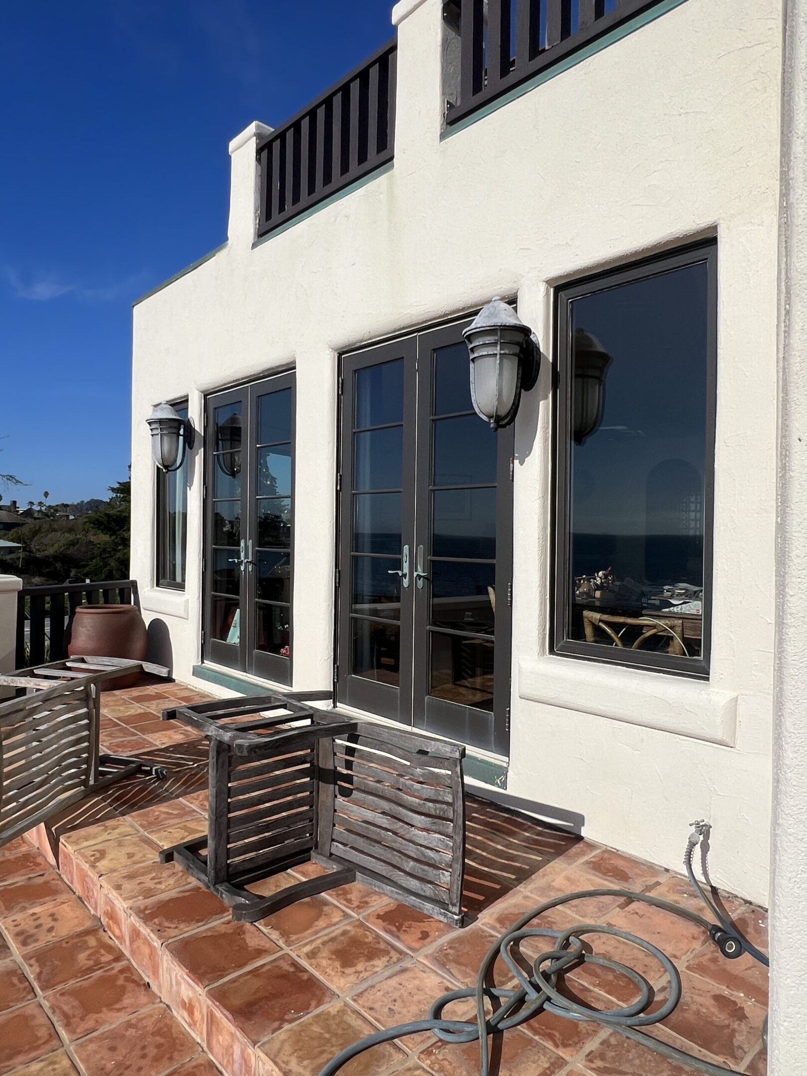 Patio with ocean view and outdoor furniture.