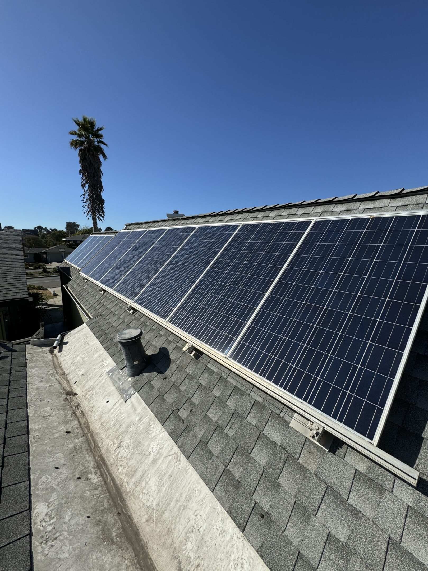Solar panels on a rooftop under sunlight.